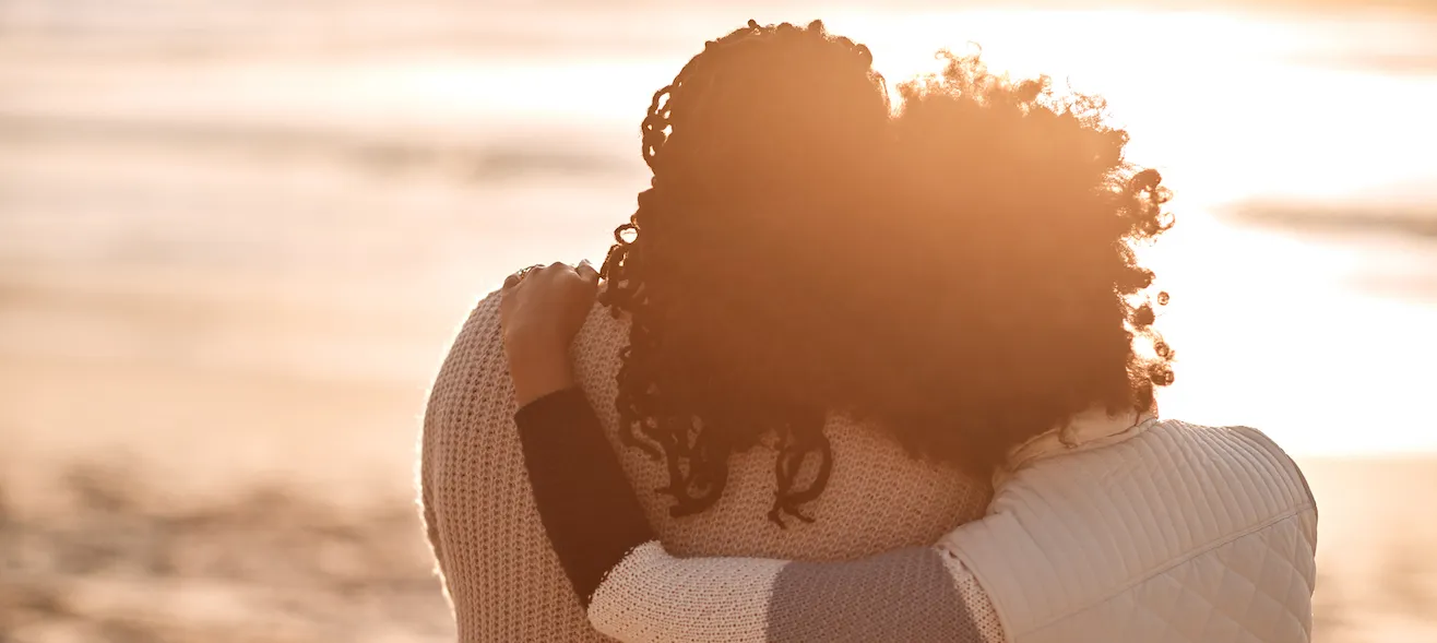 Woman and her mother enjoying beach sunset